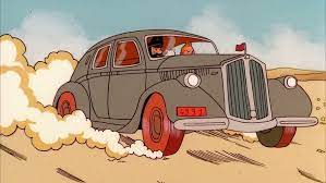 Lancia Aprilia grise avec pneus rouges qui roulent à vive allure dans le désert dans Tintin au pays de l'or noir.