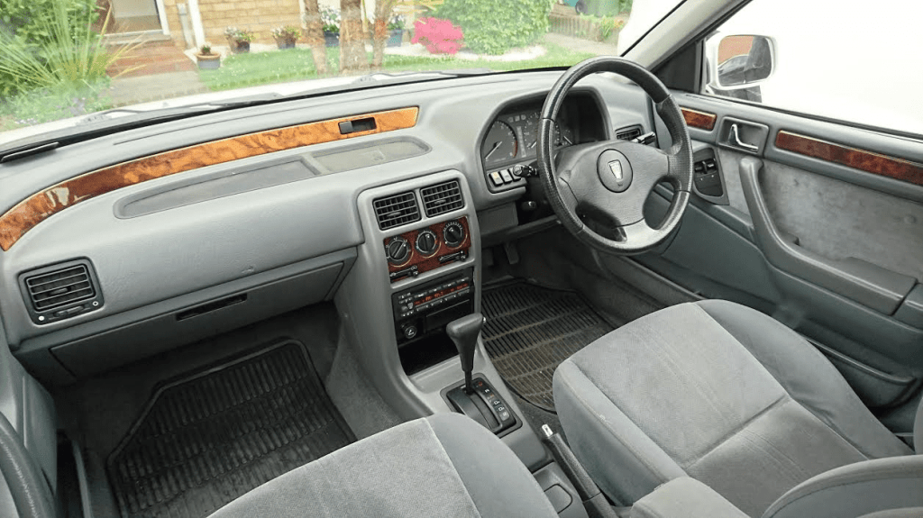 Intérieur Rover série 200 avec placage bois en ronce de noyer, volant trois branches et boîte auto.